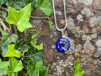 Cobalt blue round lapis donut pendant set in silver wire