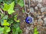 Cobalt blue round lapis donut pendant set in silver wire